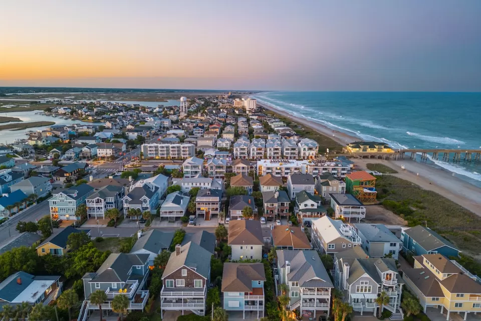 Aerial view of dense neighborhood with beach homes on coast in Wrightsville Beach, North Carolina.